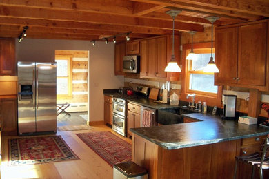 Inspiration for a large rustic l-shaped light wood floor kitchen remodel in Other with an undermount sink, recessed-panel cabinets, medium tone wood cabinets and stainless steel appliances