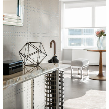 Decorative objects and a chrome mirror heighten the effect of the accent wall