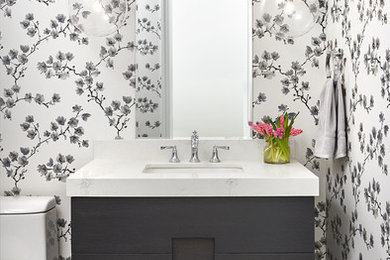 Design ideas for a mid-sized transitional powder room in Toronto with furniture-like cabinets, multi-coloured walls, an undermount sink, grey floor, white benchtops, grey cabinets, ceramic floors and marble benchtops.