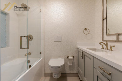 Mid-sized white tile gray floor and double-sink bathroom photo in San Francisco with a one-piece toilet, white walls, quartzite countertops, white countertops and a niche