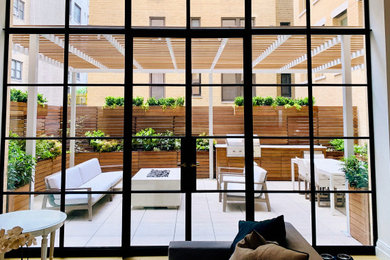 Design ideas for a modern partial sun backyard concrete paver and wood fence landscaping in New York for spring.