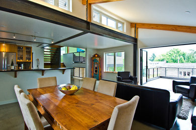 Large minimalist concrete floor great room photo in Seattle with beige walls and no fireplace
