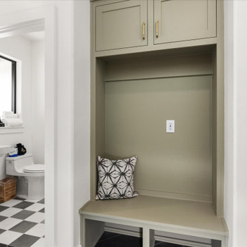 Functional entryway with built-in mud bench adjacent to a stylish powder bath wi