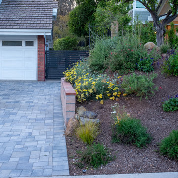 Paver driveway, metal gates, block retaining wall rebuilt to match existing wall