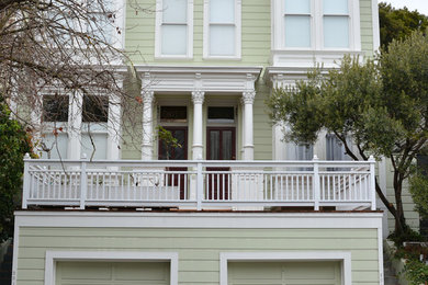 This is an example of a mid-sized contemporary three-storey green exterior in San Francisco with wood siding and a flat roof.