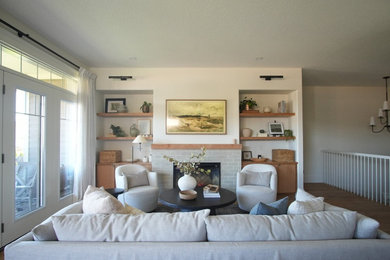 Example of a large transitional open concept medium tone wood floor and beige floor living room design in Other with beige walls, a standard fireplace, a tile fireplace and a wall-mounted tv