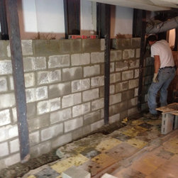 Tie backs installed and footer and reinforced wall in front between steel buttre - Products