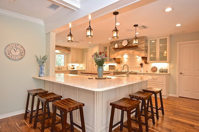 Inspiration for a large farmhouse dark wood floor kitchen remodel in Tampa with a single-bowl sink, raised-panel cabinets, white cabinets, quartzite countertops, white backsplash, stainless steel appliances, an island and white countertops