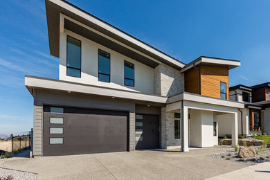 Example of a large trendy multicolored two-story mixed siding house exterior design in Vancouver
