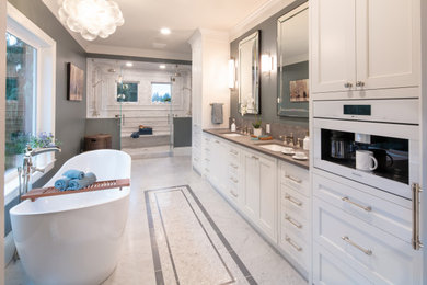 Example of a classic double-sink freestanding bathtub design in Seattle with gray countertops and a built-in vanity