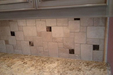 Example of a classic kitchen design in Little Rock with granite countertops and beige backsplash