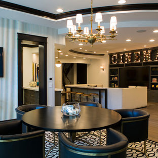 This is an example of a medium sized traditional open plan home cinema in Phoenix with medium hardwood flooring, a built-in media unit and brown floors.