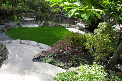 Small arts and crafts side yard partial sun outdoor sport court in San Francisco with natural stone pavers for spring.