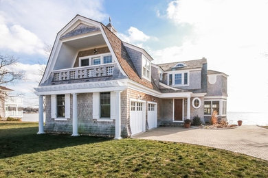 Mid-sized elegant two-story wood exterior home photo in Bridgeport with a gambrel roof