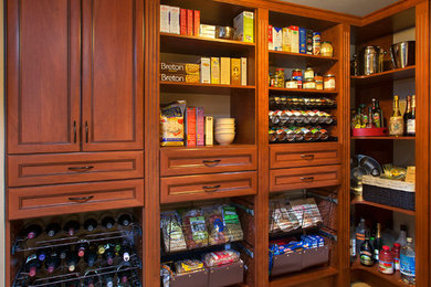 Photo of a large traditional u-shaped kitchen pantry in Denver with recessed-panel cabinets, medium wood cabinets, ceramic floors and no island.