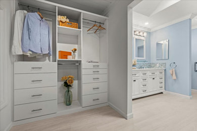 Large beach style gender-neutral porcelain tile and beige floor walk-in closet photo in San Francisco with open cabinets and white cabinets