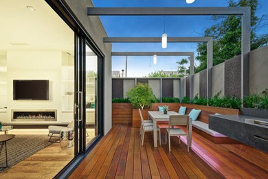 Small contemporary backyard patio in Melbourne with decking and no cover.