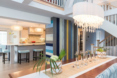 Mid-sized beach style medium tone wood floor kitchen/dining room combo photo in Boston with white walls and no fireplace