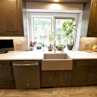 Design ideas for a large transitional l-shaped kitchen pantry in Cleveland with a farmhouse sink, raised-panel cabinets, green cabinets, quartz benchtops, white splashback, stone tile splashback, stainless steel appliances, with island and white benchtop.