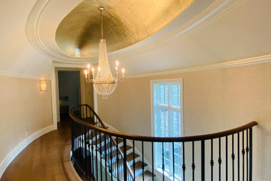 Example of a transitional wooden metal railing and wallpaper staircase design in Seattle with painted risers