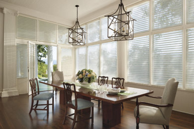 Inspiration for a transitional dining room in Other with white walls and dark hardwood floors.