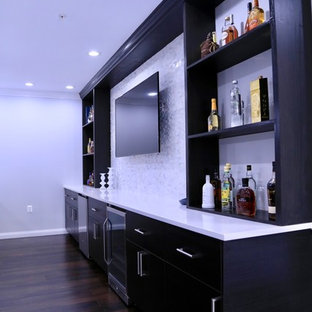 Large contemporary walk-out basement in DC Metro with grey walls, laminate floors, a standard fireplace, a tiled fireplace surround and brown floors.