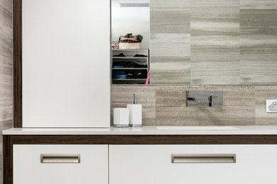This is an example of a contemporary master bathroom in Perth with white cabinets, brown tile, porcelain tile, porcelain floors, an undermount sink, engineered quartz benchtops, brown floor and white benchtops.