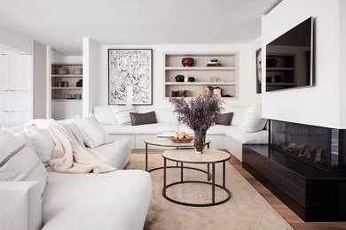 Mid-sized trendy open concept medium tone wood floor and brown floor living room photo in San Francisco with white walls, a wall-mounted tv and a ribbon fireplace