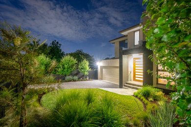 Design ideas for a small contemporary front yard full sun driveway for fall with concrete pavers, a metal fence and with path.