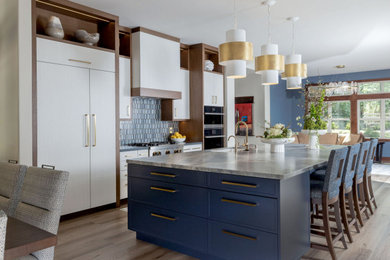 Large transitional vinyl floor and brown floor eat-in kitchen photo in Sacramento with an undermount sink, flat-panel cabinets, blue backsplash, glass tile backsplash, stainless steel appliances, an island and blue countertops