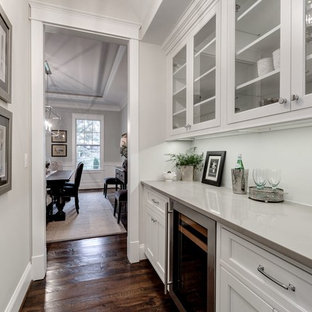 Mid-sized farmhouse kitchen pantry designs - Mid-sized farmhouse single-wall dark wood floor kitchen pantry photo in DC Metro with recessed-panel cabinets, white cabinets, quartzite countertops, white backsplash and stainless steel appliances