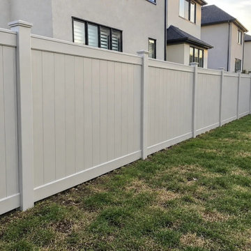 Solid tongue and groove vinyl privacy panels running along the lot line in Milto