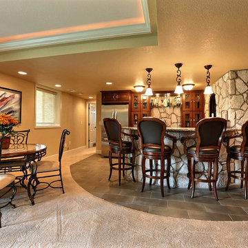 Open Basement Concept in Centennial, CO with tray ceilings and stacked stone