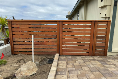 Inspiration for a brick and wood fence landscaping in Other.