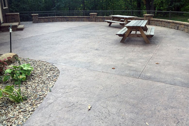 Large side yard stamped concrete patio photo in Other
