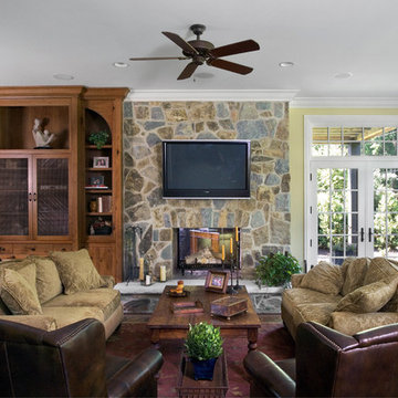 Family Room with Floor to Ceiling Knotty Pine Built in and Stone Fireplace