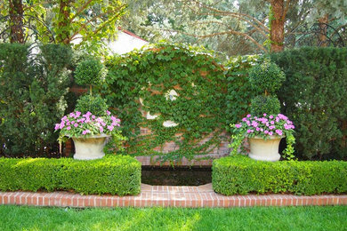 Design ideas for a traditional full sun backyard brick landscaping in Omaha.