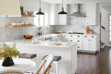 Eat-in kitchen - mid-sized transitional u-shaped medium tone wood floor and brown floor eat-in kitchen idea in Chicago with a farmhouse sink, shaker cabinets, white cabinets, quartz countertops, gray backsplash, marble backsplash, stainless steel appliances, no island and white countertops