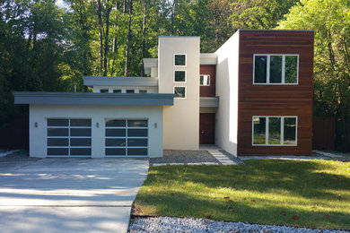 Example of a trendy white two-story wood flat roof design in Atlanta