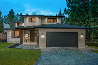 Large three-storey grey house exterior in Vancouver with concrete fiberboard siding, a gable roof and a shingle roof.