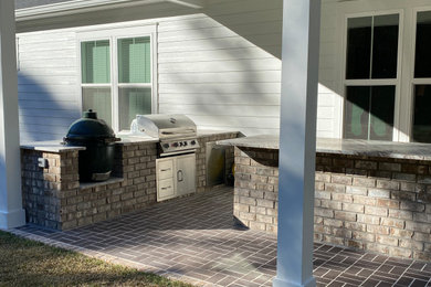 Backyard patio kitchen photo in Other