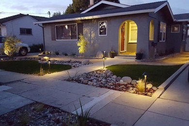 Transitional gray one-story stucco house exterior idea in Other with a shingle roof