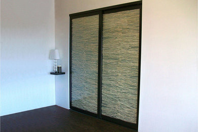 Inspiration for a mid-sized coastal master brown floor bedroom remodel in Los Angeles with white walls
