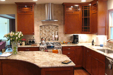 Eat-in kitchen - small craftsman u-shaped medium tone wood floor eat-in kitchen idea in Baltimore with a drop-in sink, shaker cabinets, medium tone wood cabinets, granite countertops, beige backsplash, ceramic backsplash, stainless steel appliances and an island