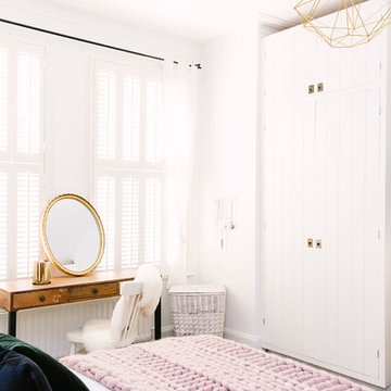 A rustic bedroom with a touch of blush and brass