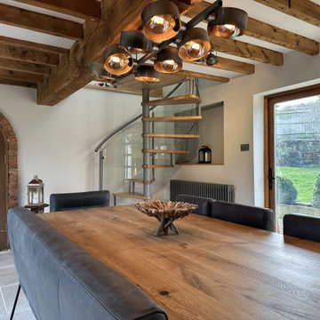 Lovely cottage spiral staircase with oak treads and curved glass railing