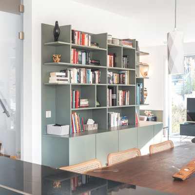 Family room library - large eclectic open concept painted wood floor family room library idea in Nuremberg with a wood stove