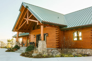 Example of a huge mountain style brown two-story wood exterior home design in Boston with a clipped gable roof