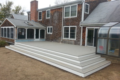 Inspiration for a large timeless brown two-story wood exterior home remodel in Providence with a shingle roof