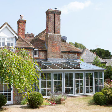 Timber framed lean-to conservatory on a traditional Sussex flint house